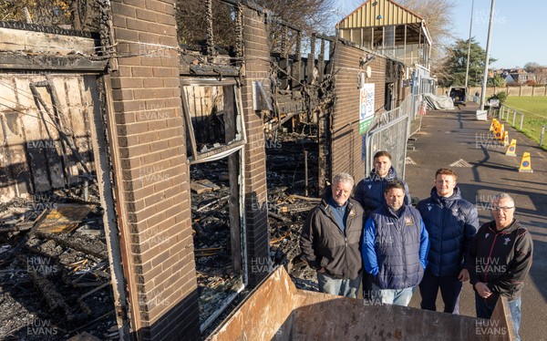 031225 - Penarth RFC Clubhouse Fire - Welsh Rugby Union Community Director Geraint John with Dan Mears, Penarth RFC Secretary and Alan Cozens Penarth RFC Commercial secretary along with Cardiff Rugby and Welsh internationals Mason Grady and Evan Lloyd at the Penarth RFC Clubhouse which was devastated by a recent fire