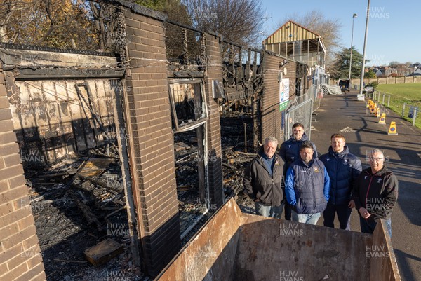 031225 - Penarth RFC Clubhouse Fire - Welsh Rugby Union Community Director Geraint John with Dan Mears, Penarth RFC Secretary and Alan Cozens Penarth RFC Commercial secretary along with Cardiff Rugby and Welsh internationals Mason Grady and Evan Lloyd at the Penarth RFC Clubhouse which was devastated by a recent fire