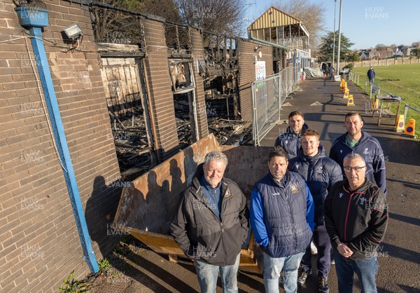 031225 - Penarth RFC Clubhouse Fire - Welsh Rugby Union Community Director Geraint John with Dan Mears, Penarth RFC Secretary and Alan Cozens Penarth RFC Commercial secretary along with Cardiff Rugby and Welsh internationals Mason Grady and Evan Lloyd and Cardiff Rugby Club head coach Corniel van Zyl at the Penarth RFC Clubhouse which was devastated by a recent fire