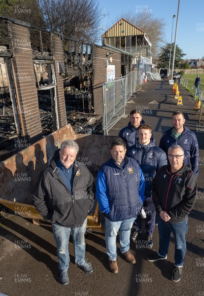 031225 - Penarth RFC Clubhouse Fire - Welsh Rugby Union Community Director Geraint John with Alan Cozens Penarth RFC Commercial secretary, left and Dan Mears, Penarth RFC Secretary along with Cardiff Rugby and Welsh internationals Mason Grady and Evan Lloyd and Cardiff Rugby Club head coach Corniel van Zyl at the Penarth RFC Clubhouse which was devastated by a recent fire