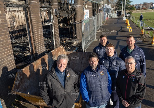 031225 - Penarth RFC Clubhouse Fire - Welsh Rugby Union Community Director Geraint John with Dan Mears, Penarth RFC Secretary and Alan Cozens Penarth RFC Commercial secretary along with Cardiff Rugby and Welsh internationals Mason Grady and Evan Lloyd and Cardiff Rugby Club head coach Corniel van Zyl at the Penarth RFC Clubhouse which was devastated by a recent fire