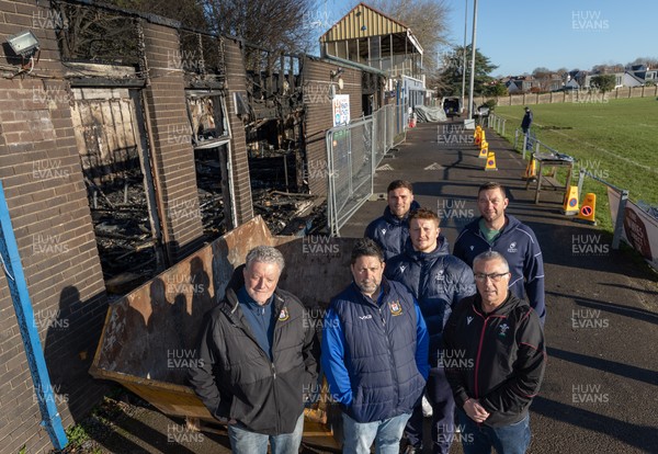 031225 - Penarth RFC Clubhouse Fire - Welsh Rugby Union Community Director Geraint John with Dan Mears, Penarth RFC Secretary and Alan Cozens Penarth RFC Commercial secretary along with Cardiff Rugby and Welsh internationals Mason Grady and Evan Lloyd and Cardiff Rugby Club head coach Corniel van Zyl at the Penarth RFC Clubhouse which was devastated by a recent fire
