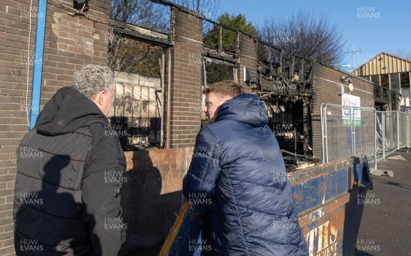 031225 - Penarth RFC Clubhouse Fire - Dan Mears, Penarth RFC Secretary with Cardiff Rugby and Welsh internationals Mason Grady and Evan Lloyd at the Penarth RFC Clubhouse which was devastated by a recent fire