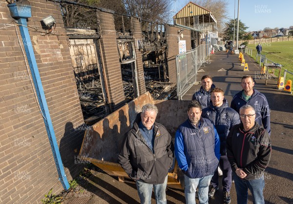 031225 - Penarth RFC Clubhouse Fire - Welsh Rugby Union Community Director Geraint John with Dan Mears, Penarth RFC Secretary and Alan Cozens Penarth RFC Commercial secretary along with Cardiff Rugby and Welsh internationals Mason Grady and Evan Lloyd and Cardiff Rugby Club head coach Corniel van Zyl at the Penarth RFC Clubhouse which was devastated by a recent fire
