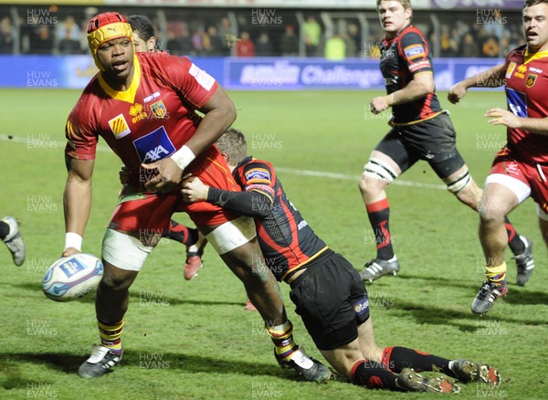 14.01.12 - Perpignan v Dragons - Amiln Challenge Cup Robins Tchale Watchou of Perpignan is tackled by Wayne Evans of Dragons. 