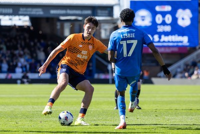 060426 - Peterborough United v Cardiff City - Sky Bet League 1 - Rubin Colwill of Cardiff City and Kyrell Lisbie of Peterborough United