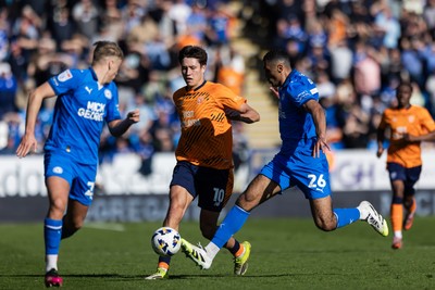 060426 - Peterborough United v Cardiff City - Sky Bet League 1 - Rubin Colwill of Cardiff City tackled by David Okagbue of Peterborough United