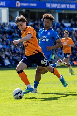 060426 - Peterborough United v Cardiff City - Sky Bet League 1 - Cian Ashford of Cardiff City holds the ball against James Dornelly of Peterborough United