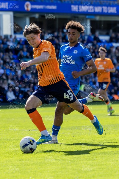 060426 - Peterborough United v Cardiff City - Sky Bet League 1 - Cian Ashford of Cardiff City holds the ball against James Dornelly of Peterborough United