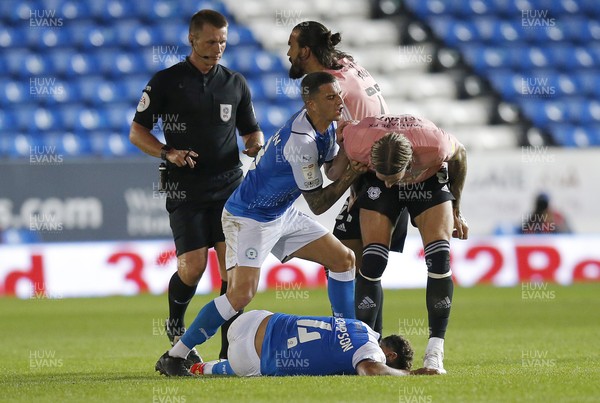 170821 - Peterborough v Cardiff City - Sky Bet Championship - Nathan Thompson of Peterborough is injured on the ground with Aden Flint of Cardiff bending over and Oliver Norburn of Peterborough pushing him away