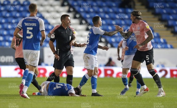 170821 - Peterborough v Cardiff City - Sky Bet Championship - Nathan Thompson of Peterborough is injured on the ground as Aden Flint of Cardiff and Oliver Norburn of Peterborough square up with referee Thomas Bramall looking on