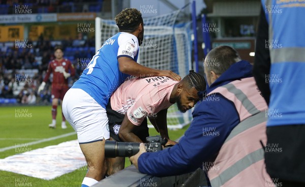 170821 - Peterborough v Cardiff City - Sky Bet Championship - Leandra Bacuna of Cardiff and Nathan Thompson of Peterborough crash into the barriers