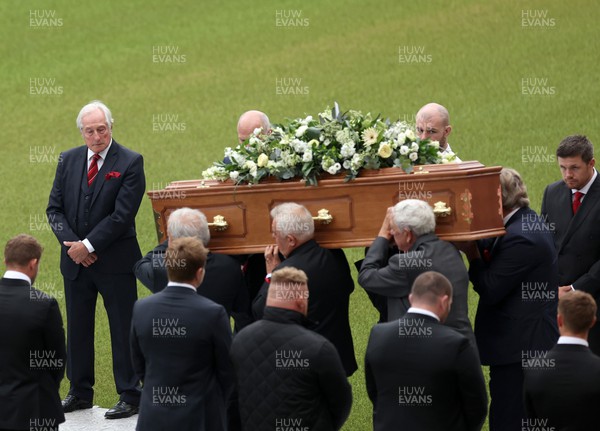 240622 - Memorial service for Phil Bennett OBE, former Llanelli, Wales & Lions player at Parc y Scarlets - Sir Gareth Edwards looks on as the coffin is brought out