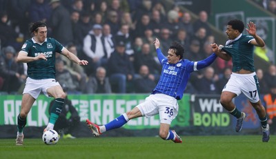 210226 - Plymouth Argyle v Cardiff City - Sky Bet League 1 - Omari Kellyman of Cardiff City battles for the ball with Caleb Watts of Plymouth Argyle