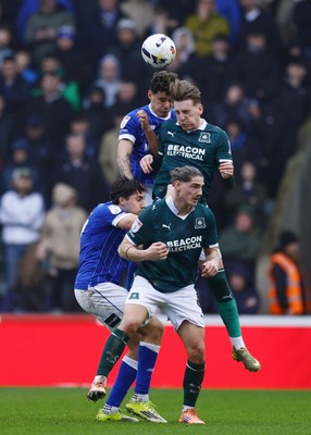 210226 - Plymouth Argyle v Cardiff City - Sky Bet League 1 - Alex Robertson of Cardiff City challenges for the aerial ball with Alex Mitchell of Plymouth Argyle