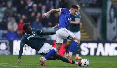 210226 - Plymouth Argyle v Cardiff City - Sky Bet League 1 - Alex Robertson of Cardiff City battles for the ball with Brendan Wiredu of Plymouth Argyle