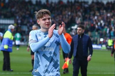 220225 - Plymouth Argyle v Cardiff City - Sky Bet Championship - Cian Ashford of Cardiff City applauds the travelling fans at the end of the game