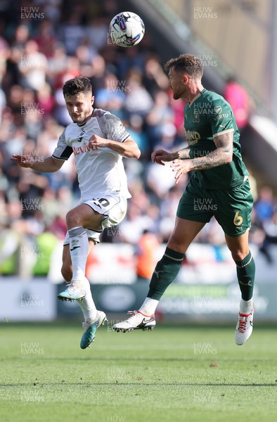 071023 - Plymouth Argyle v Swansea City, EFL Sky Bet Championship - Liam Cullen of Swansea City and Dan Scarr of Plymouth Argyle compete for the ball