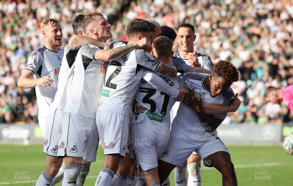 071023 - Plymouth Argyle v Swansea City, EFL Sky Bet Championship - Ollie Cooper of Swansea City is mobbed by team mates after scoring Swansea’s second goal