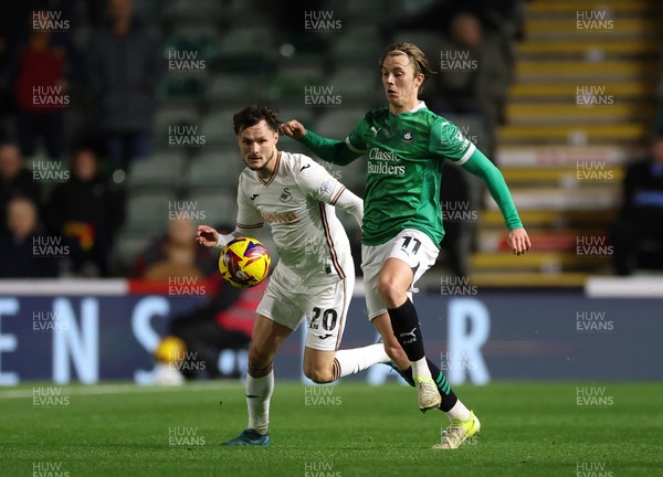 101224 Plymouth Argyle v Swansea City, EFL Sky Bet Championship - Callum Wright of Plymouth holds off Liam Cullen of Swansea City