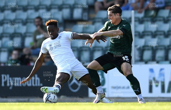 200721 - Plymouth Argyle v Swansea City - Preseason Friendly - Jamal Lowe of Swansea City and Conor Grant of Argyle compete