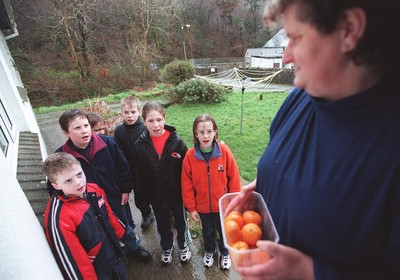 060199 Pontfaen feature - The Children of Llanychllwydog CP School in Pontfaen sing at the doors of the neighbourhood homes to celebrate their New Year