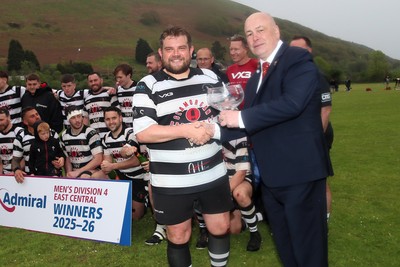 020526 - Ogmore Vale v Pontyclun - Admiral National League 4 East Central - Jo Williams, the captain of Pontyclun RFC is presented with trophy by WRU representative Lloyd Morgan as Pontyclun RFC players celebrate winning the league