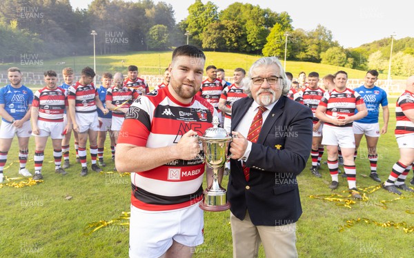 250523 - Pontypool RFC captain Scott Matthews is presented with the Admiral Championship League trophy by WRU board member Bryn Parker