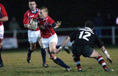 080203 - Pontypool v Llanelli - Principality Cup - Llanelli's Garan Evans escapes tackler Jonathan Hawker