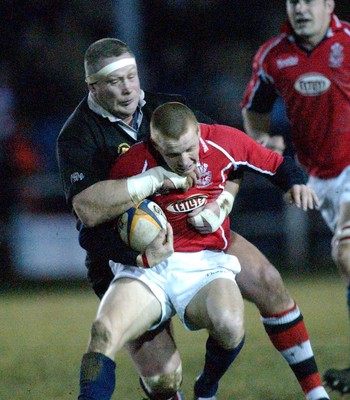 080203 - Pontypool v Llanelli - Principality Cup - Llanelli's Garan Evans is collared by Poolers' Mark Jones