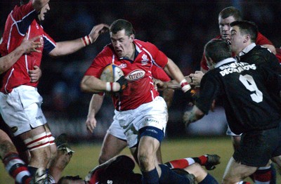 080203 - Pontypool v Llanelli - Principality Cup -  Llanelli's Guy Easterby bursts through gap avoiding Nicky Lloyd (rt)