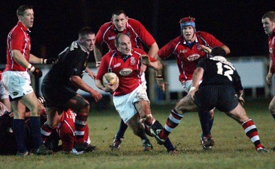 080203 - Pontypool v Llanelli - Principality Cup -  Llanelli's Neil Boobyer charges at Jonathan Hawker (rt)