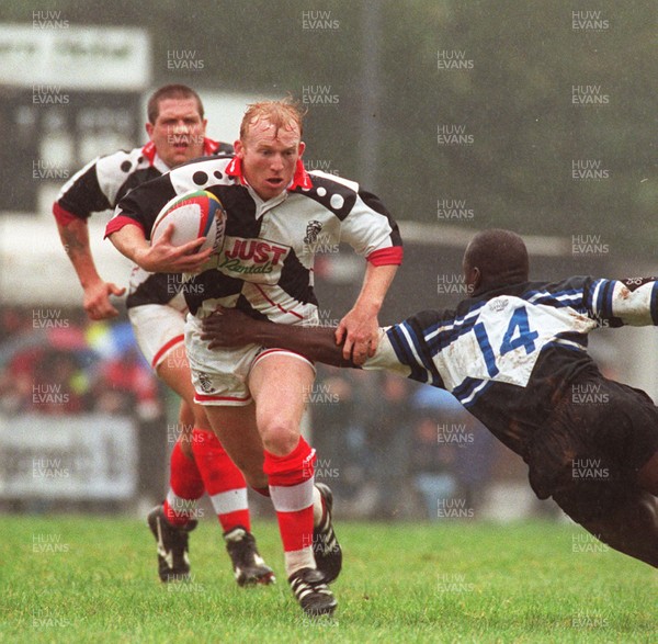 191096 - Pontypridd v Bath - Neil Jenkins of Pontypridd is tackled by Adedayo Adebayo