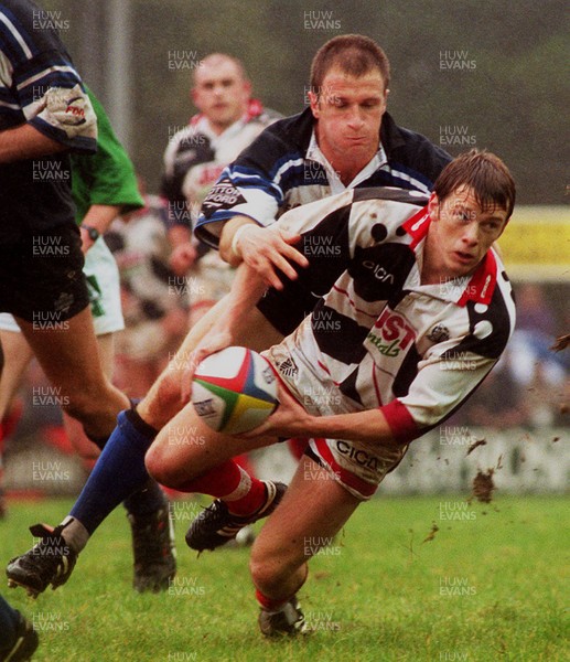 191096 - Pontypridd v Bath - Kevin Morgan of Pontypridd gets the ball away from Mike Catt