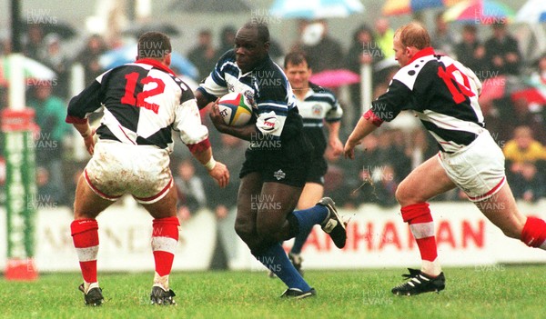 191096 - Pontypridd v Bath - Adedayo Adebayo takes on Steele Lewis and Neil Jenkins