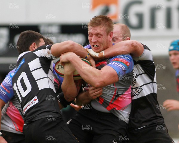 011114 - Pontypridd RFC v Bedwas RFC - Principality Premiership -Craig Locke of Pontypridd is tackled by Richard Powell(10) and Phil Rees of Bedwas