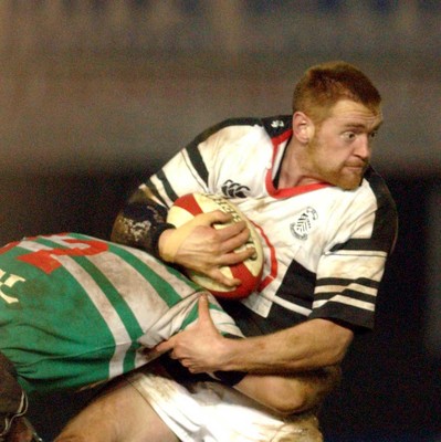 210203 - Pontypridd v Caerphilly - Welsh Premiership - Pontypridd's Brett Davey looks for support as he gets tackled by Sam Cox