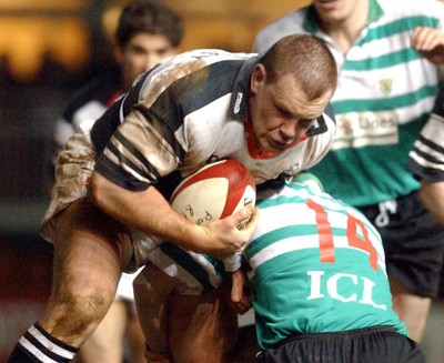 210203 - Pontypridd v Caerphilly - Welsh Premiership - Pontypridd's Neil Hennessey drives into Ryan Howells