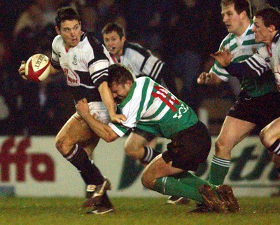 210203 - Pontypridd v Caerphilly - Welsh Premiership - Pontypridd's Jason Lewis looks to pass as he is tackled by Justin Thomas