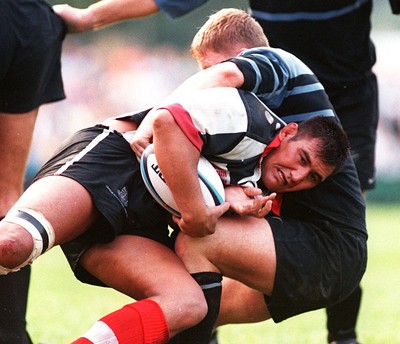 160897 - Pontypridd v Cardiff - Dale McIntosh is tackled by Gwyn Jones