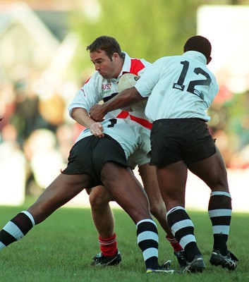 041195 - Pontypridd v Fiji - David Manley of Pontypridd is tackled by Opeti Turuva and Rasoloslo Bogisa