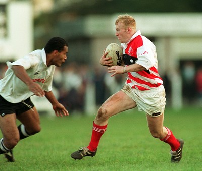 041195 - Pontypridd v Fiji - Neil Jenkins of Pontypridd takes on Rasolosolo Bogisa