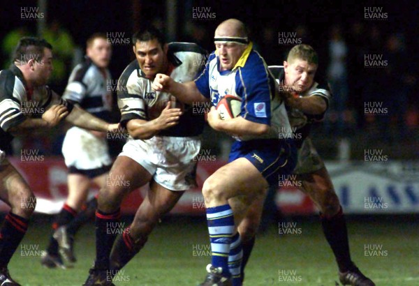 031101 - Pontypridd v Leeds - Parker Pen Shield - Leeds' Mike Shelly is tackled by Dale McIntosh (lt) and Richard Field