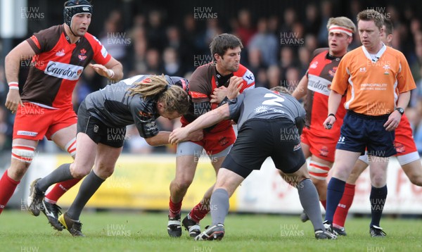 19.05.11 - Pontypridd v Llanelli - Principality Premiership Play-Off Final - Johnny Lewis of Llanelli is tackled by Wayne O'Connor and Kristian Dacey of Pontypridd. 