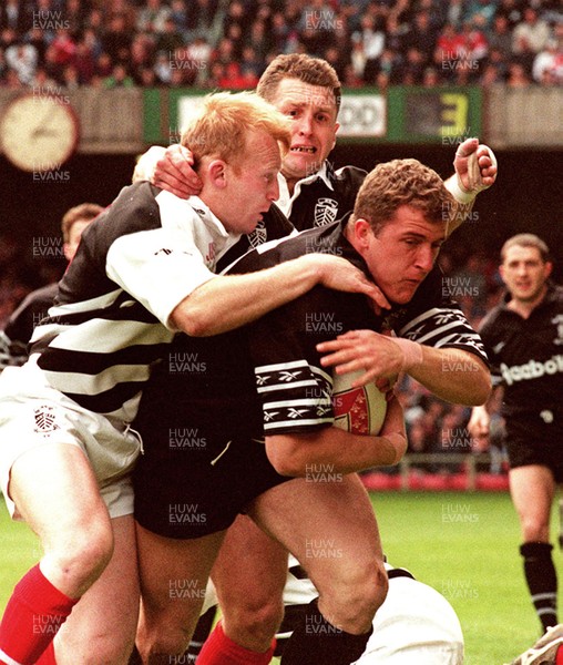 040596 - Pontypridd v Neath - SWALEC Cup Final -  Neath's Leigh Davies dives in to score first try despite the tackle from Neil Jenkins (lt) and Steele Lewis 