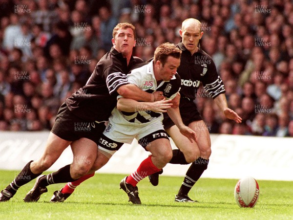 040596 - Pontypridd v Neath - SWALEC Cup Final -  Pontypridd's David Manley is tackled by Leigh Davies 