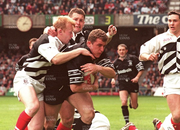 040596 - Pontypridd v Neath - SWALEC Cup Final -  Neath's Leigh Davies dives in to score first try despite the tackle from Neil Jenkins (lt) and Steele Lewis 