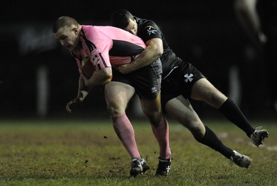 10.03.11 - Pontypridd v Neath - Principality Premiership - Kristian Dacey of Pontypridd is tackled by Stephen Thomas of Neath. 