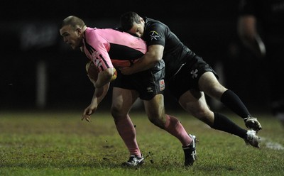 10.03.11 - Pontypridd v Neath - Principality Premiership - Kristian Dacey of Pontypridd is tackled by Stephen Thomas of Neath. 