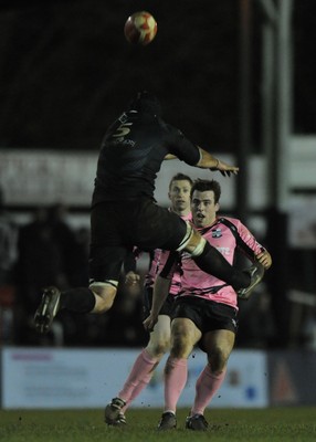 10.03.11 - Pontypridd v Neath - Principality Premiership - Simon Humberstone of Pontypridd chips the ball past Nathan Bonner-Evans of Neath. 